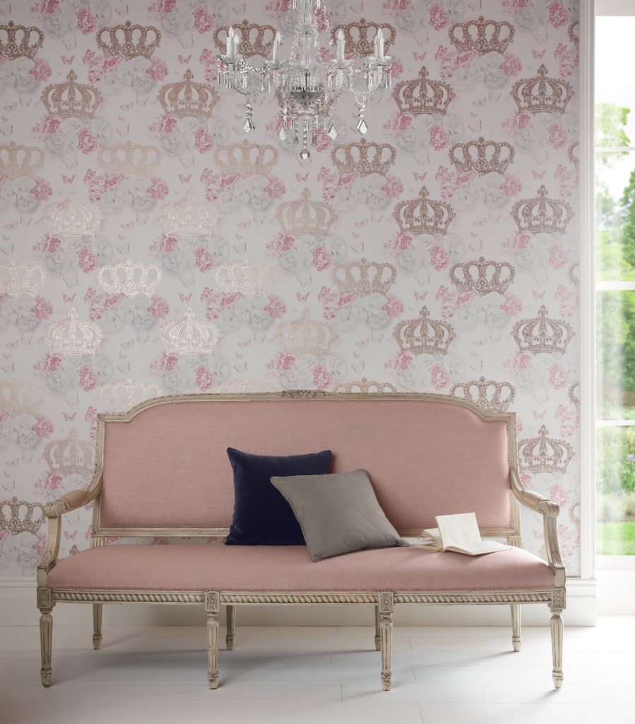shot of pale pink sofa with graham and brown wallpaper in gold and pink crown pattern