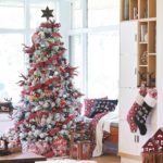 white flocked christmas tree with stocking and ornaments in tradtional reds and white