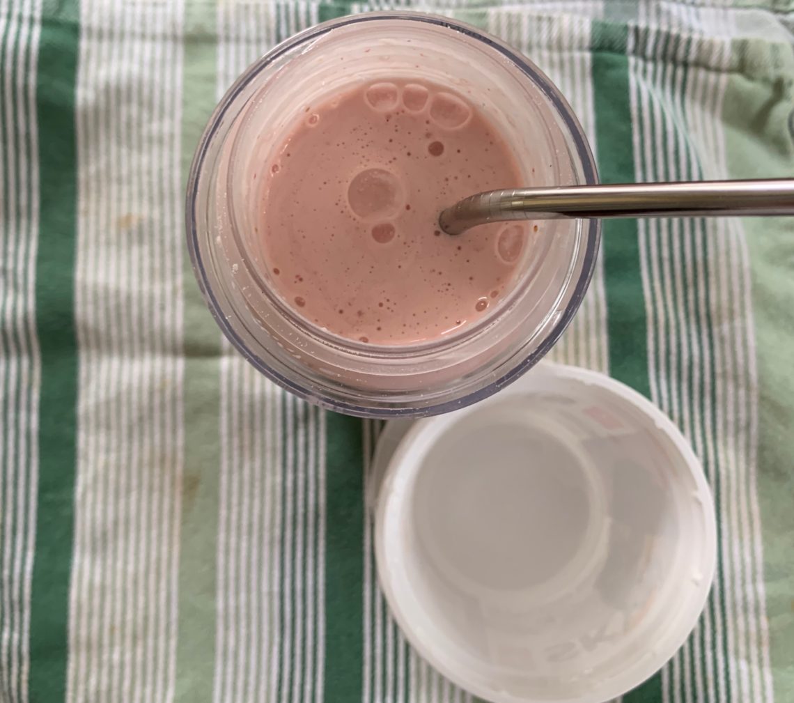Strawberry smoothie with reusable straw.