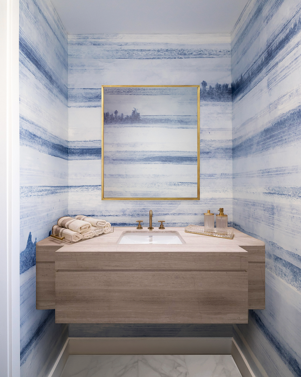 A powder room with ombre blue wallpaper mural