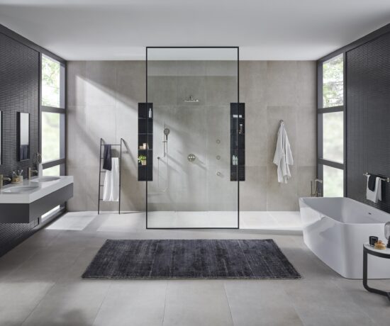 A modern bathroom with open plan shower and minimalist design features and fixtures