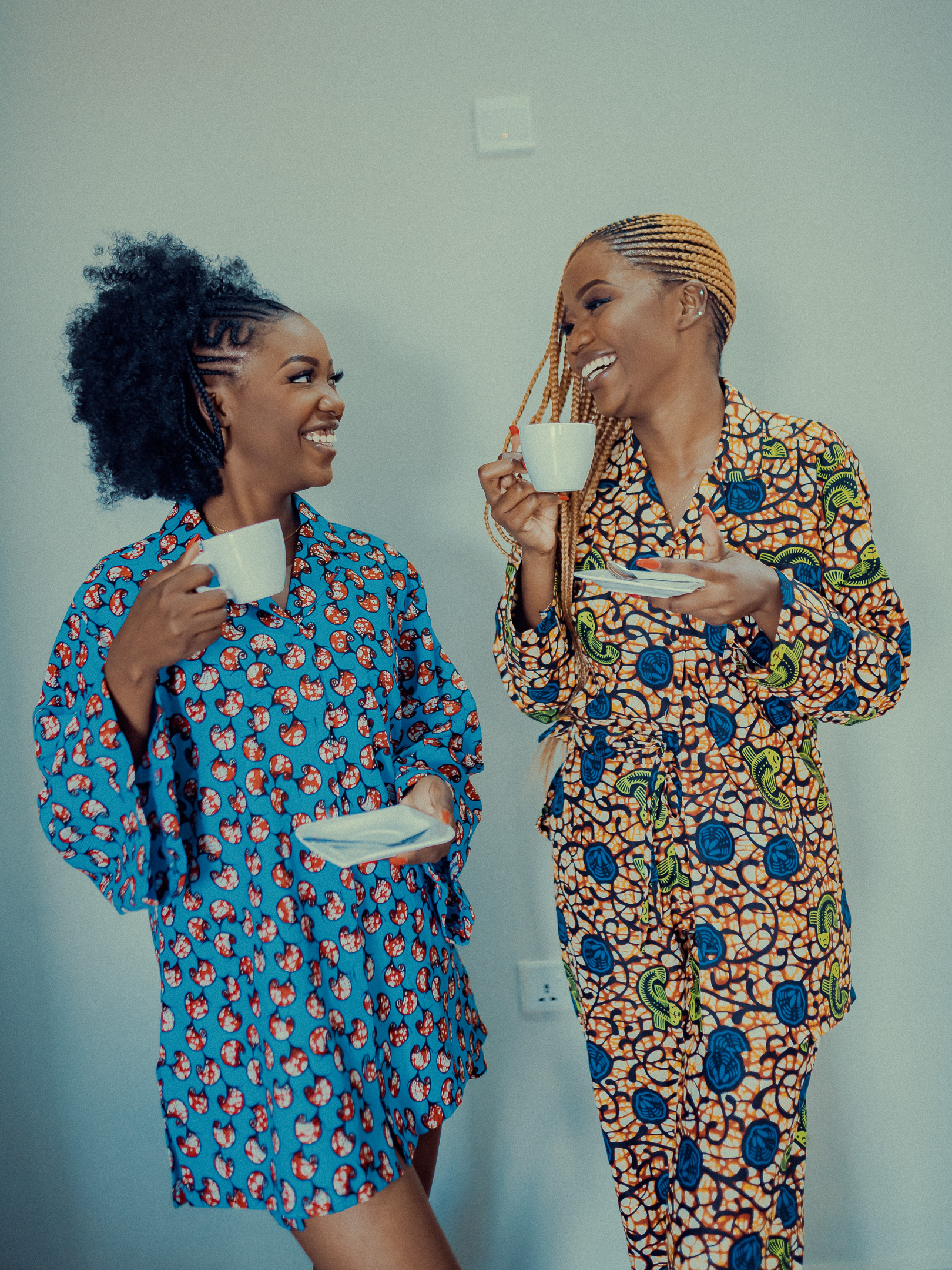 Two woman talking about self care while wearing brightly coloured loungewear designed and made in Africa. d loungewear designed and maede