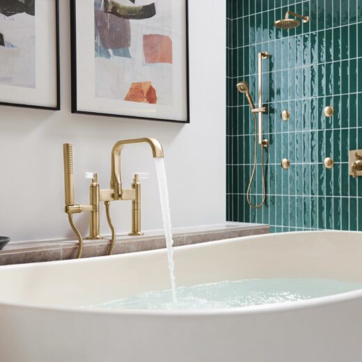 A tub filler in gold from Brizo's Allaria line in a modern bath design