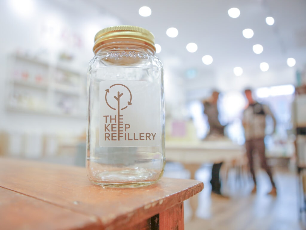 Glass jar with logo for The Keep Refillery., a Toronto store that sells sells personal care and home products in reusable containers.